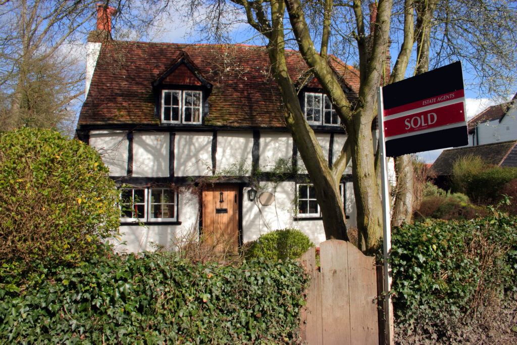 Old home with a sold sign